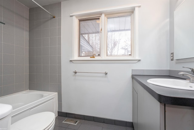 full bathroom featuring tile patterned flooring, vanity, toilet, and tiled shower / bath