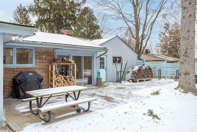 view of snow covered rear of property