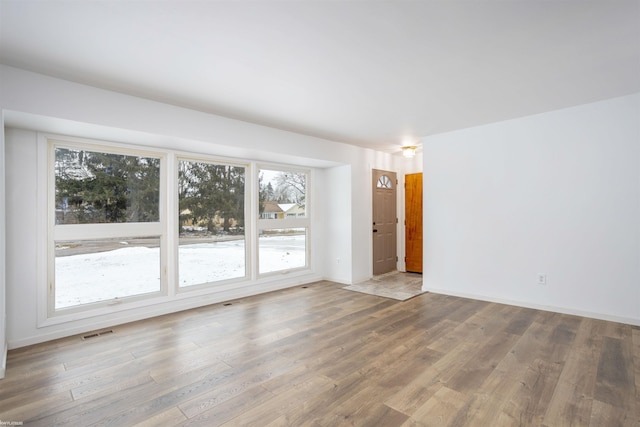 empty room with hardwood / wood-style floors