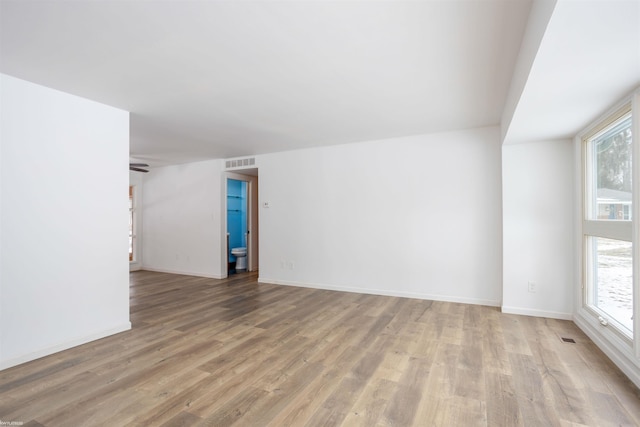 unfurnished room with plenty of natural light and light hardwood / wood-style flooring