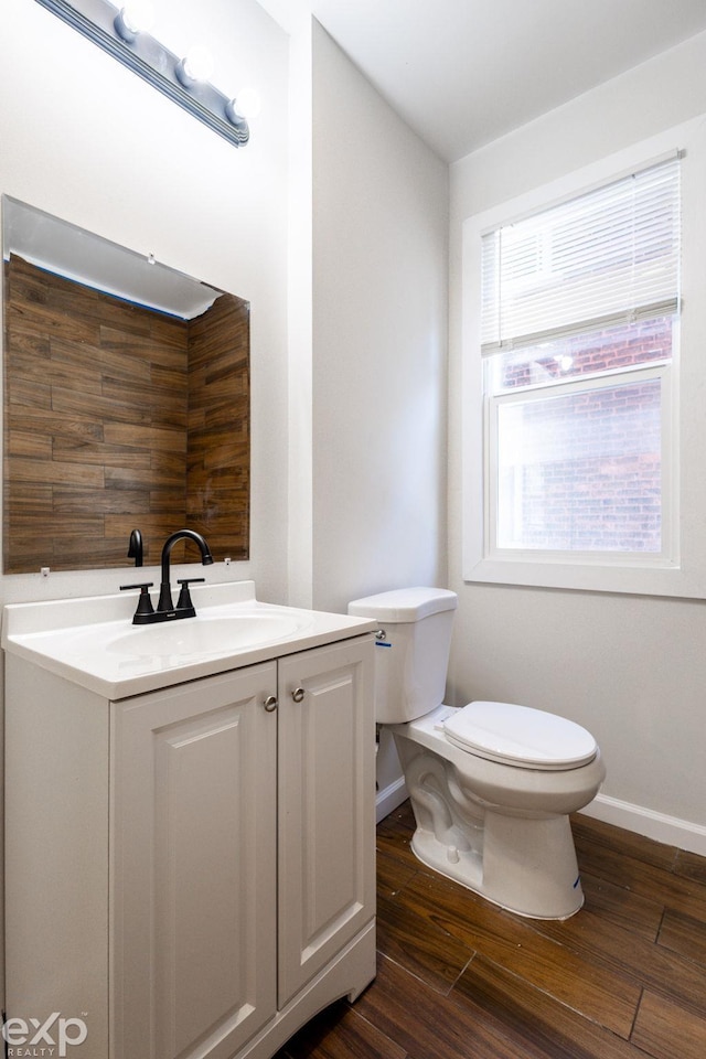 bathroom featuring vanity, hardwood / wood-style floors, and toilet