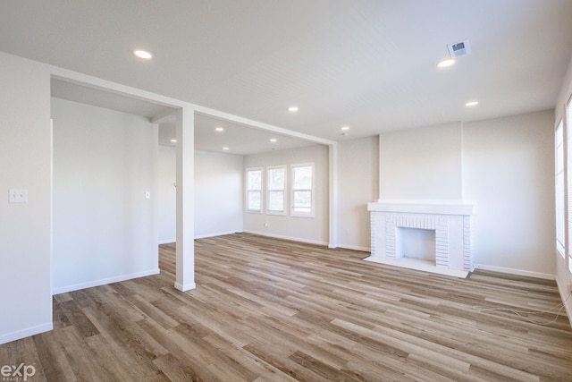 unfurnished living room featuring a fireplace and light wood-type flooring