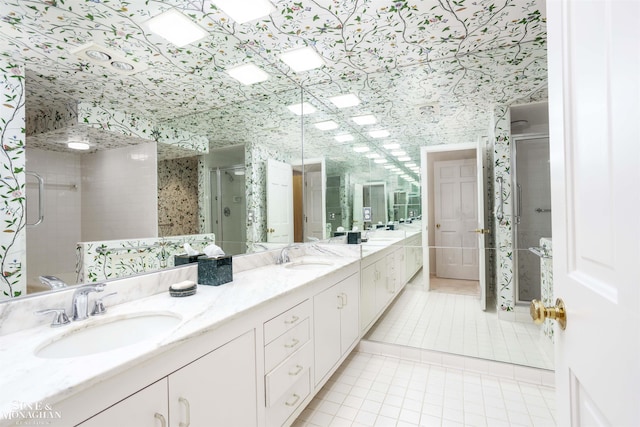 bathroom featuring tile patterned flooring, vanity, and walk in shower