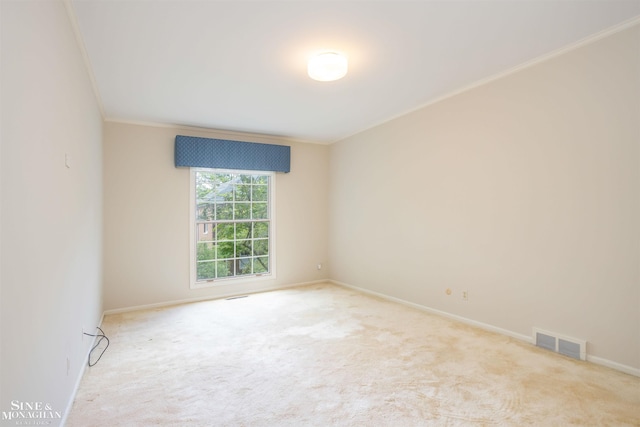 spare room featuring light carpet and ornamental molding