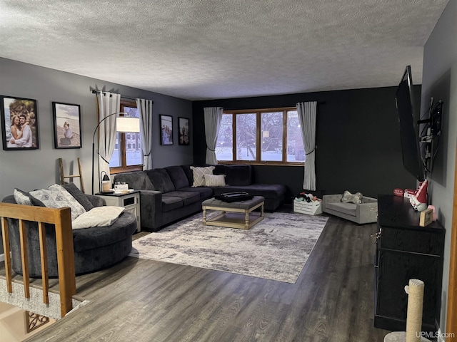 living room with dark hardwood / wood-style floors and a textured ceiling