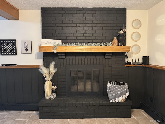 details featuring a brick fireplace and a textured ceiling