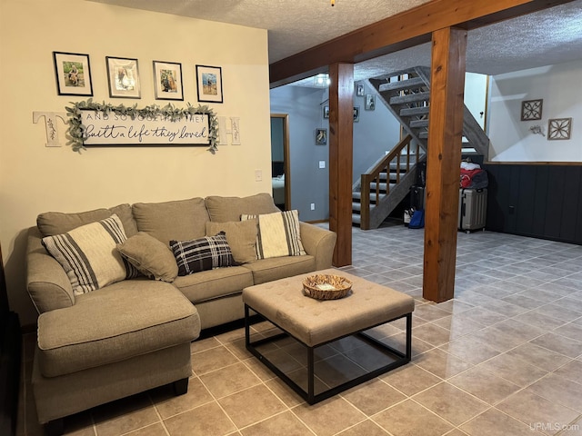 living room with tile patterned flooring and a textured ceiling