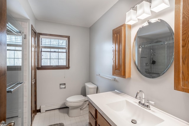 bathroom with baseboard heating, vanity, an enclosed shower, and toilet