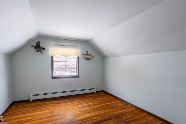 bonus room featuring hardwood / wood-style floors, vaulted ceiling, and a baseboard radiator