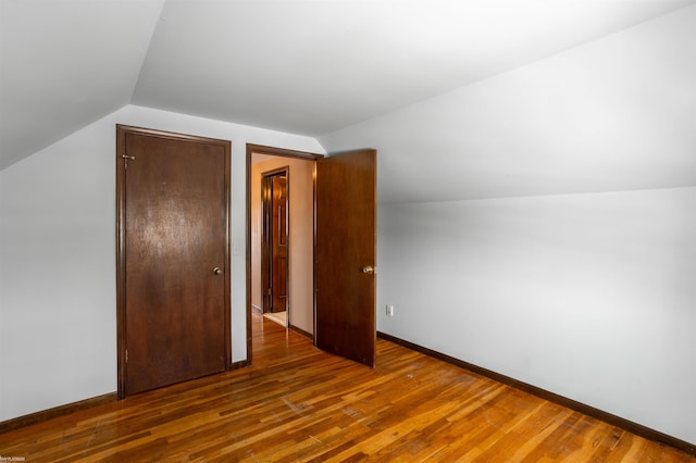 bonus room featuring dark wood-type flooring and lofted ceiling