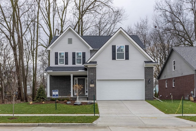 view of front of property featuring a garage and a front yard