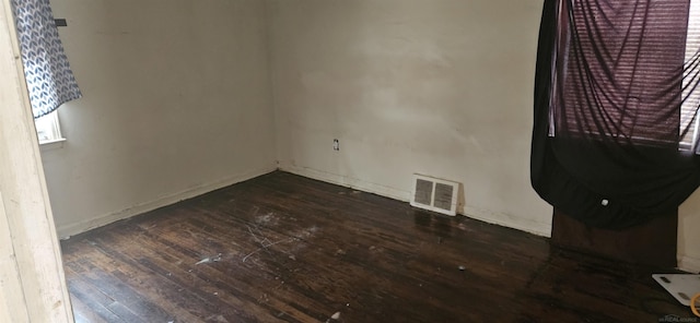 empty room with dark hardwood / wood-style flooring