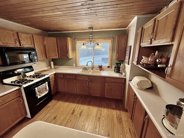 kitchen with light hardwood / wood-style flooring, hanging light fixtures, black appliances, wooden ceiling, and sink