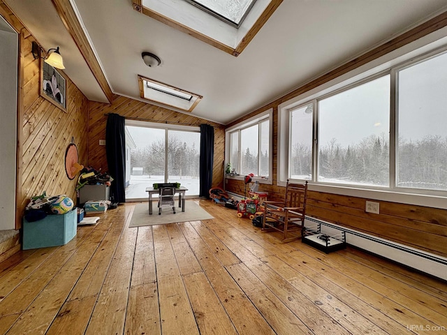 unfurnished sunroom featuring vaulted ceiling with skylight