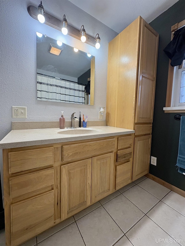 bathroom with vanity and tile patterned floors