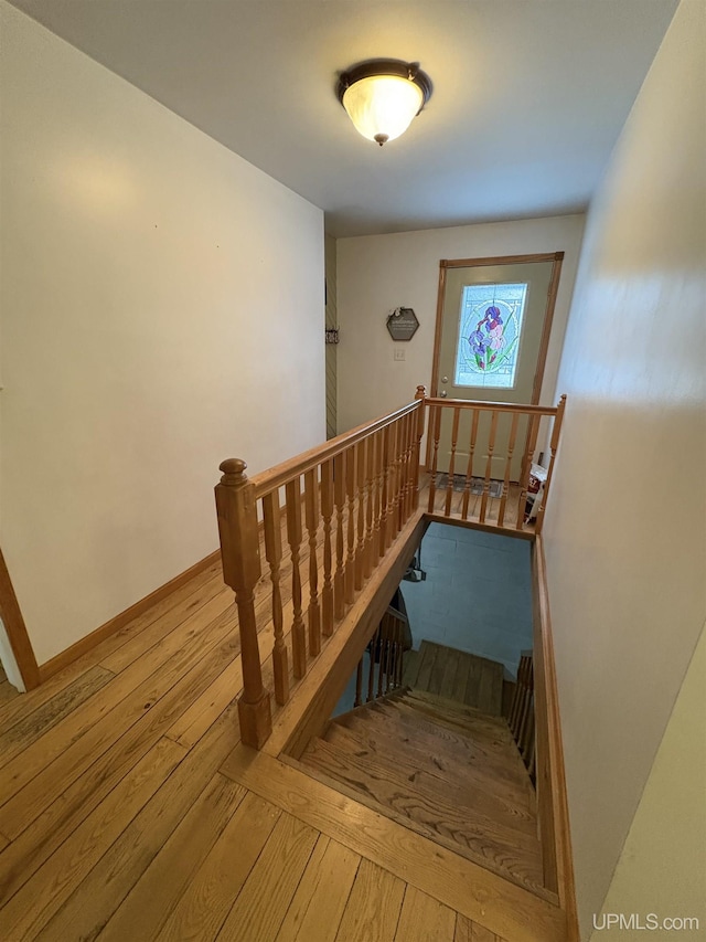 stairs with hardwood / wood-style flooring