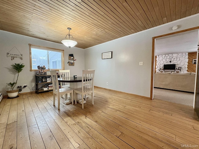 dining area with wood ceiling and light hardwood / wood-style flooring