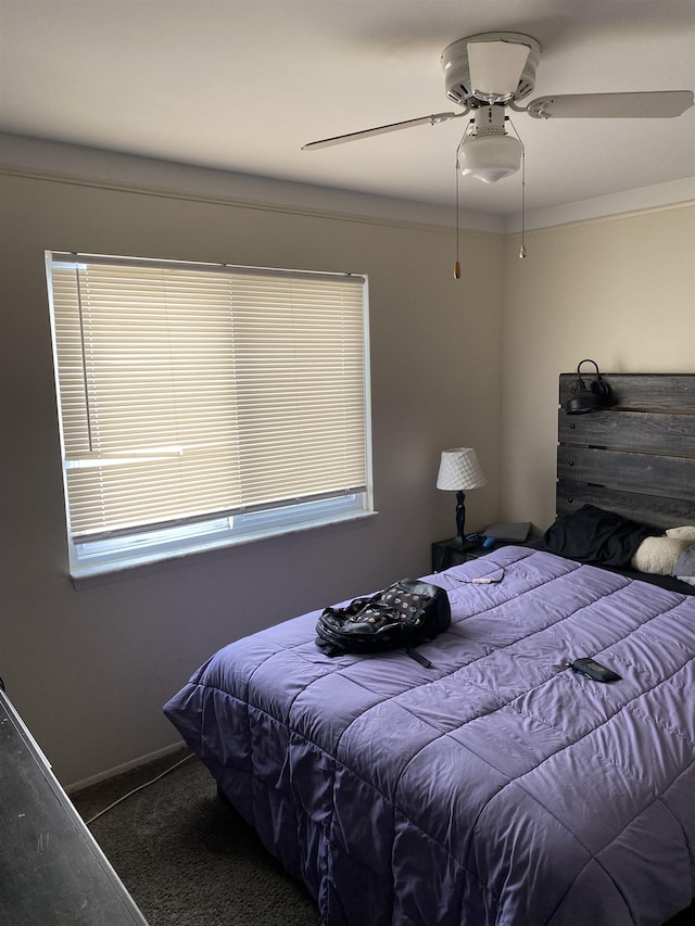 carpeted bedroom featuring multiple windows, ceiling fan, and crown molding