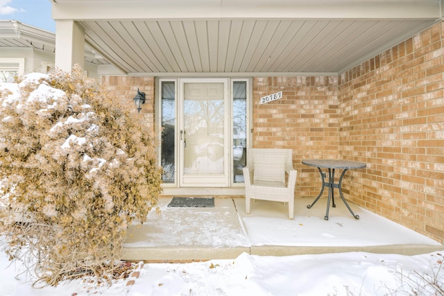 view of snow covered property entrance