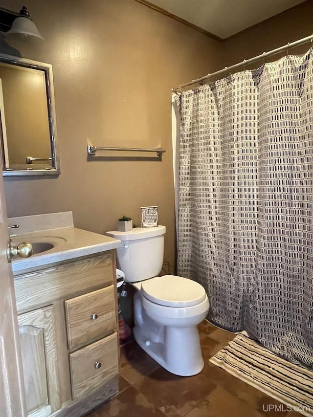 bathroom featuring vanity, toilet, and walk in shower