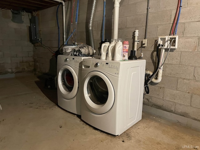 clothes washing area featuring electric panel and separate washer and dryer