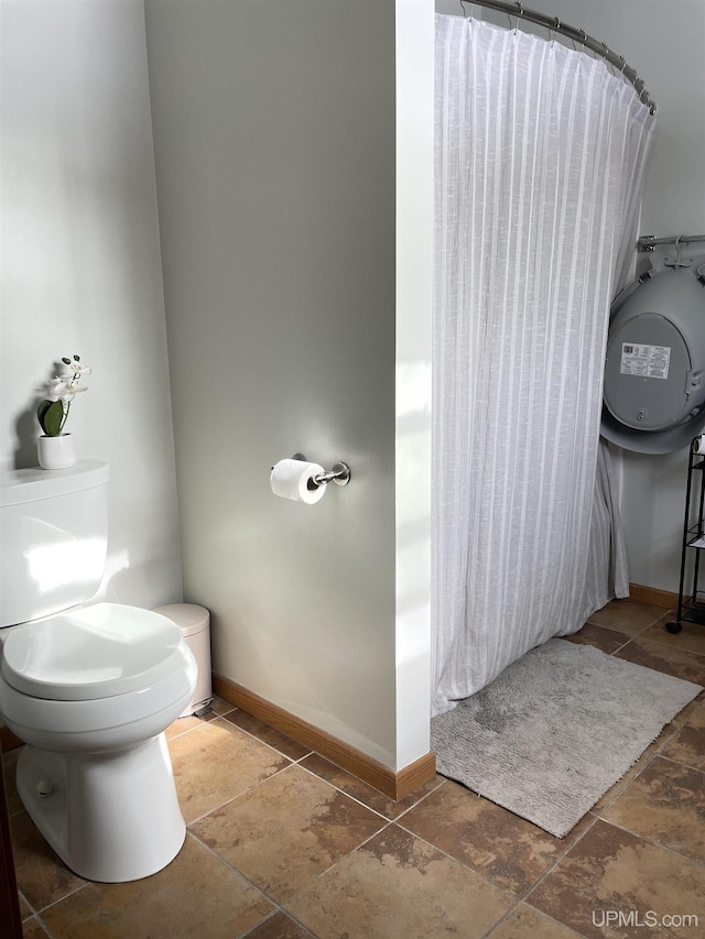 bathroom featuring toilet and walk in shower