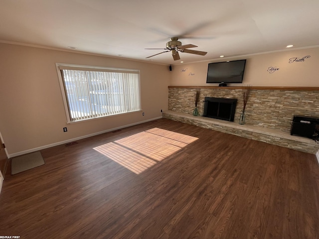 unfurnished living room featuring ceiling fan, a stone fireplace, crown molding, and dark hardwood / wood-style flooring