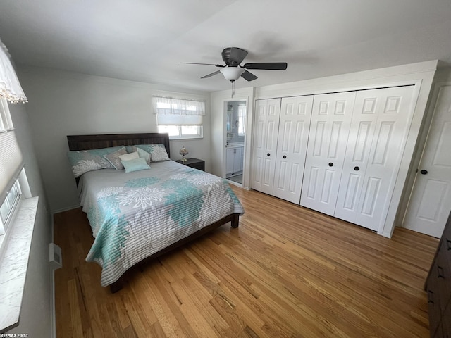 bedroom with hardwood / wood-style flooring, ceiling fan, and a closet