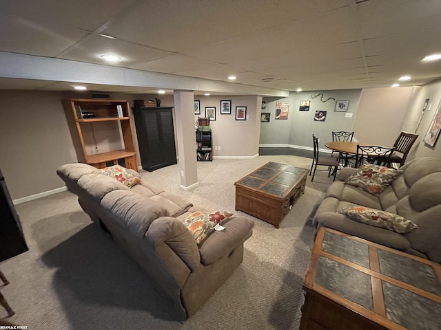 carpeted living room featuring a paneled ceiling