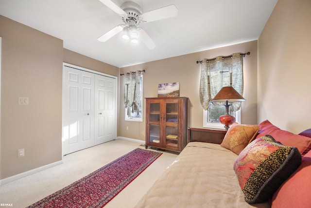 bedroom with light carpet, a closet, and ceiling fan