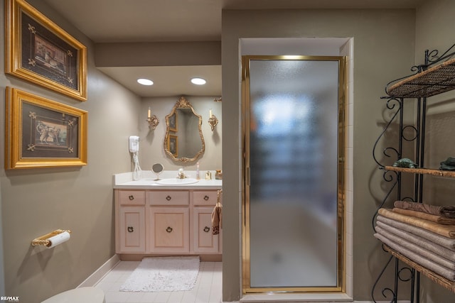 bathroom with tile patterned floors, a shower with shower door, and vanity