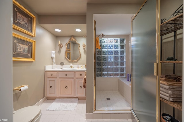 bathroom with tile patterned floors, toilet, vanity, and an enclosed shower