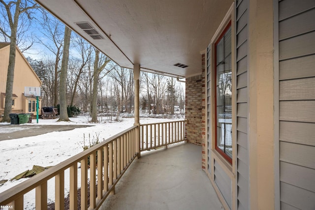 view of snow covered back of property