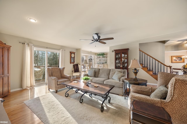 living room with light hardwood / wood-style floors and ceiling fan