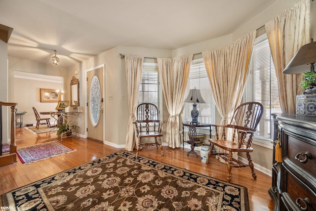 sitting room with a wealth of natural light and hardwood / wood-style flooring