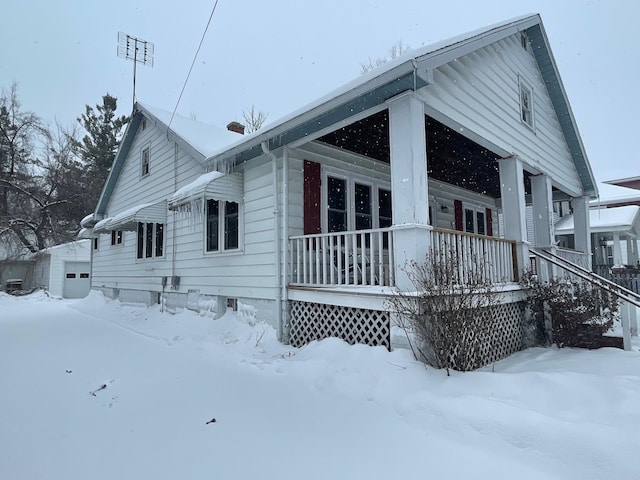 view of snow covered exterior with a porch