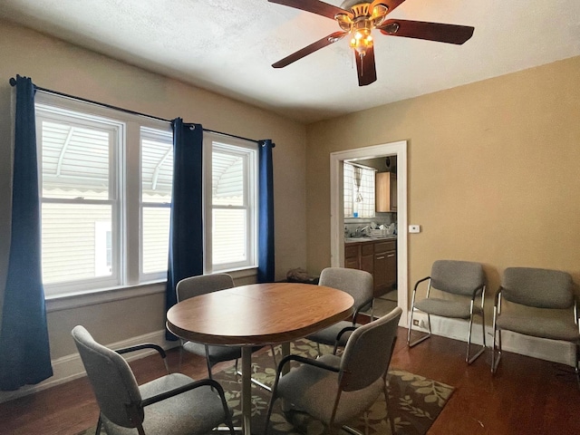 dining space featuring ceiling fan and dark wood-type flooring