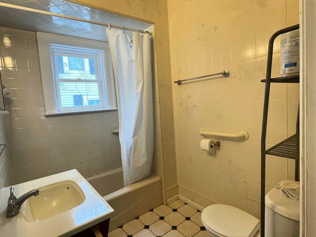 full bathroom featuring tile walls, vanity, toilet, and shower / bath combo with shower curtain