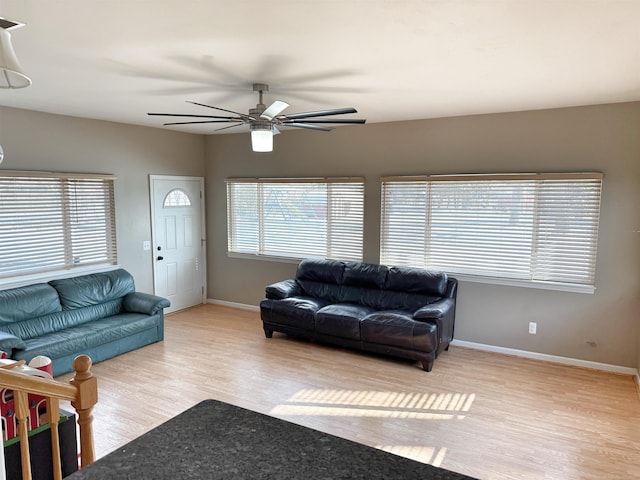 living room with light hardwood / wood-style floors and ceiling fan