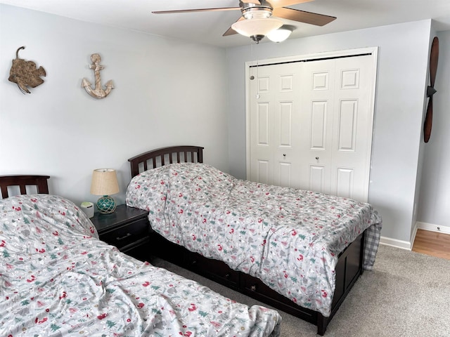 carpeted bedroom with a closet and ceiling fan