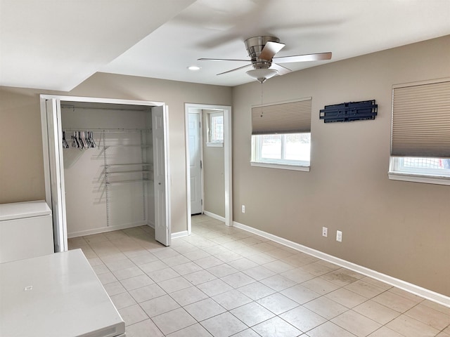 unfurnished bedroom with ceiling fan, light tile patterned floors, and a closet