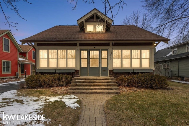 bungalow-style house with a lawn