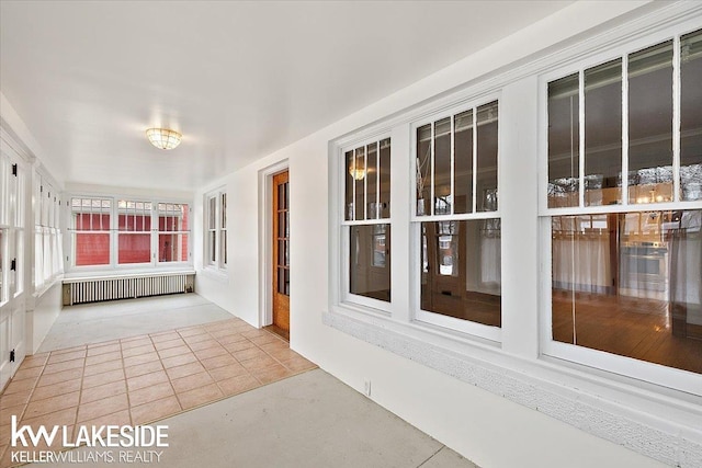 unfurnished sunroom with radiator