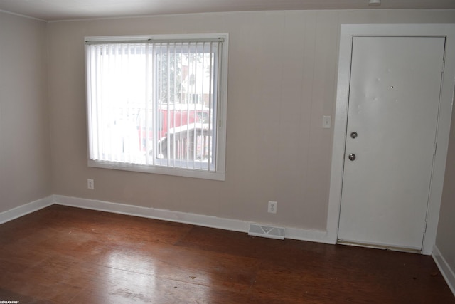 unfurnished room featuring dark hardwood / wood-style flooring