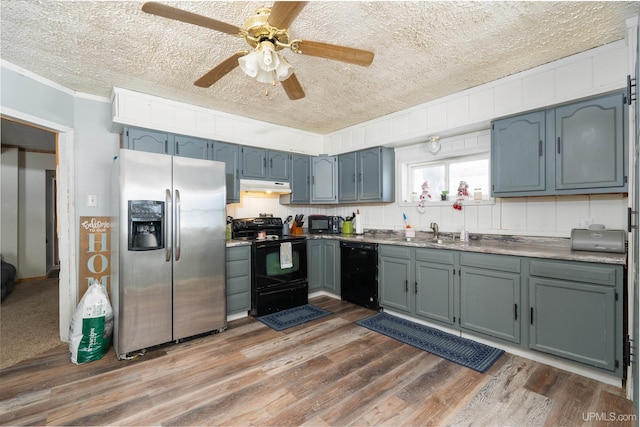 kitchen with black appliances, sink, a textured ceiling, crown molding, and dark hardwood / wood-style floors