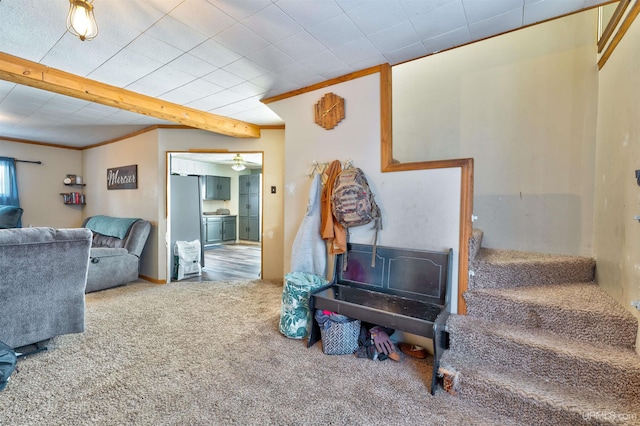 interior space featuring beam ceiling, carpet flooring, and crown molding