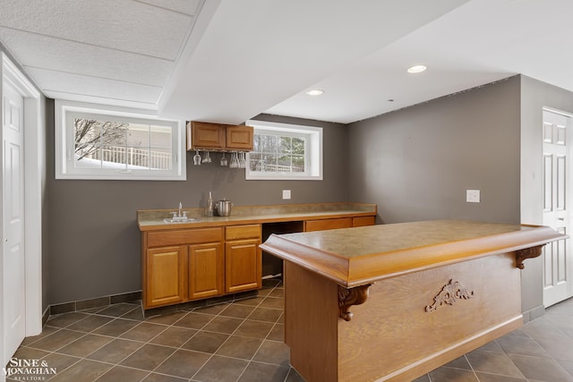 kitchen featuring sink and dark tile patterned floors