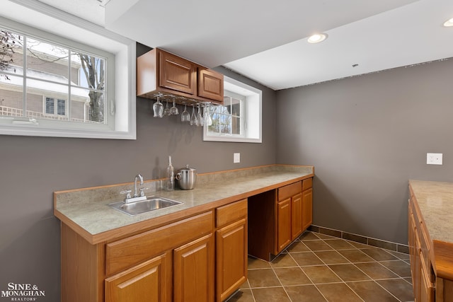 kitchen featuring sink, dark tile patterned floors, and a healthy amount of sunlight