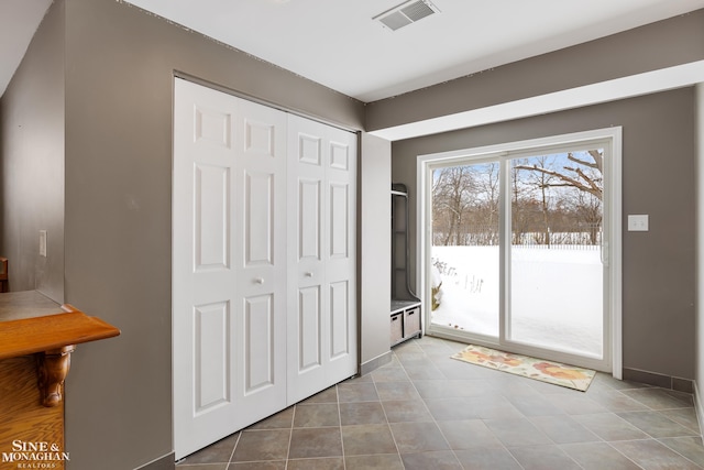 doorway with light tile patterned flooring