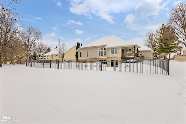 view of snow covered back of property